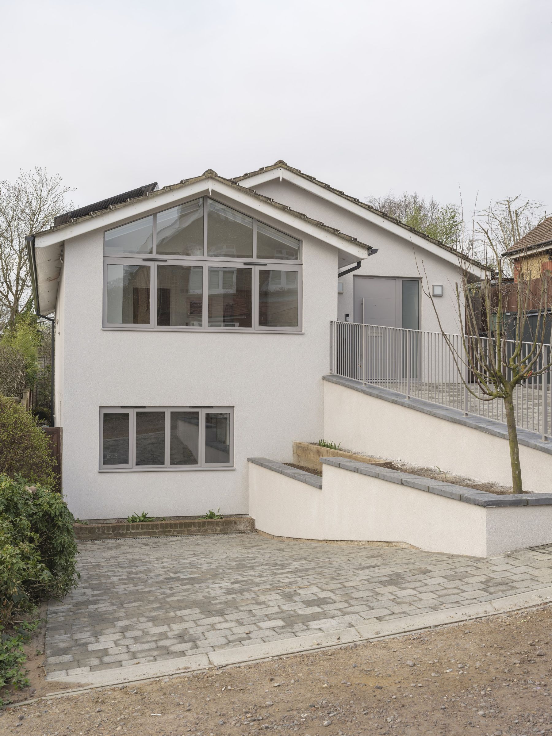 Whole-House External Refurbishment: Render, Gable Glazing & New Levels